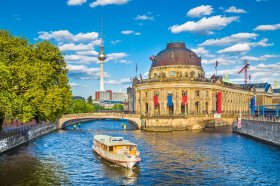 View of UNESCO World Heritage Site Museumsinsel (Museum Island) with excursion boat on Spree river, Berlin, Germany